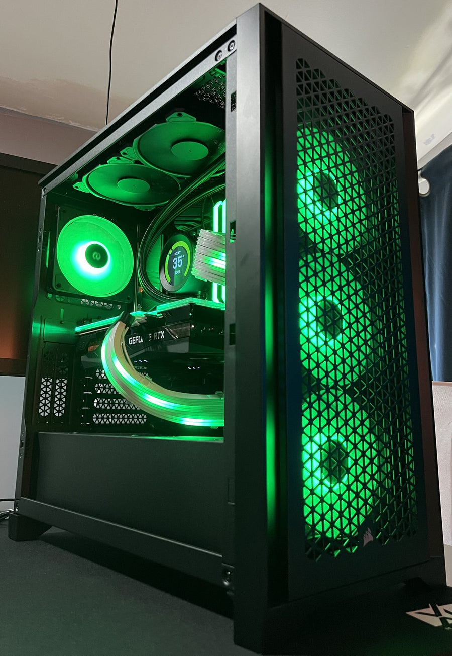Custom gaming PC build with green RGB fans in a black mesh case