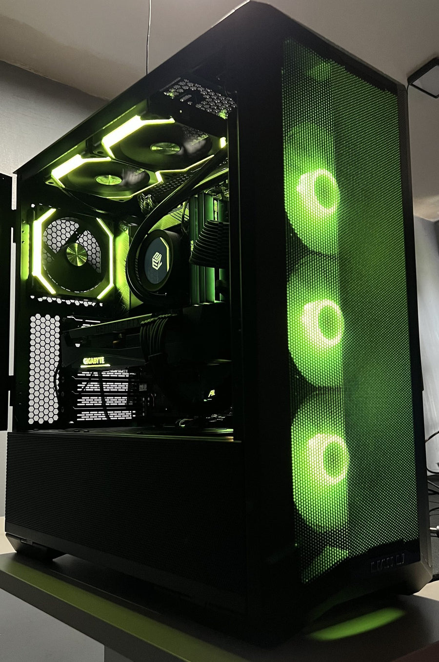 Custom gaming PC build with green lighting in a black case