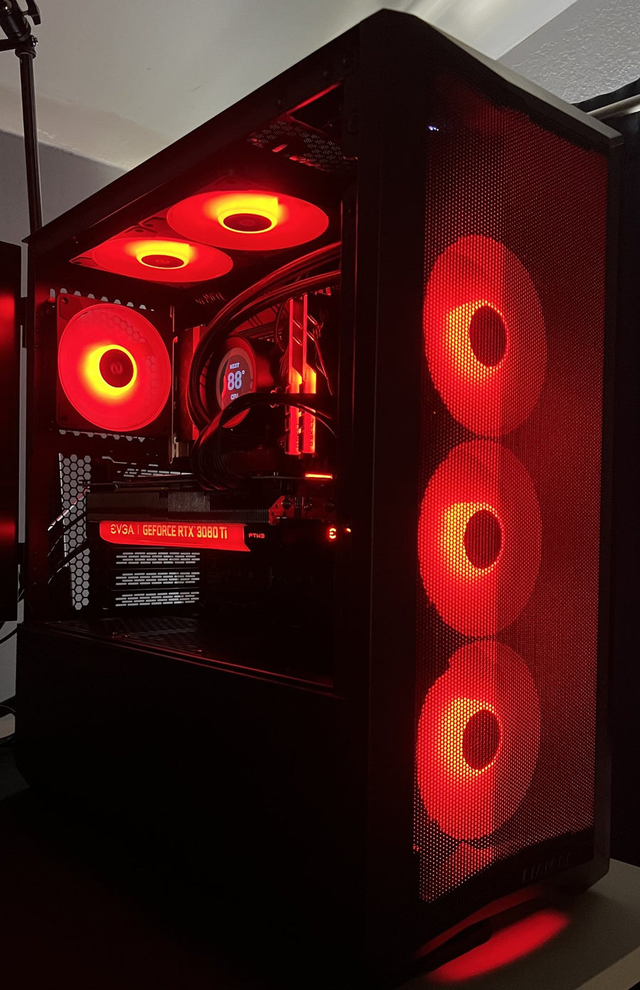 Custom gaming PC build with red fan lighting in a black case